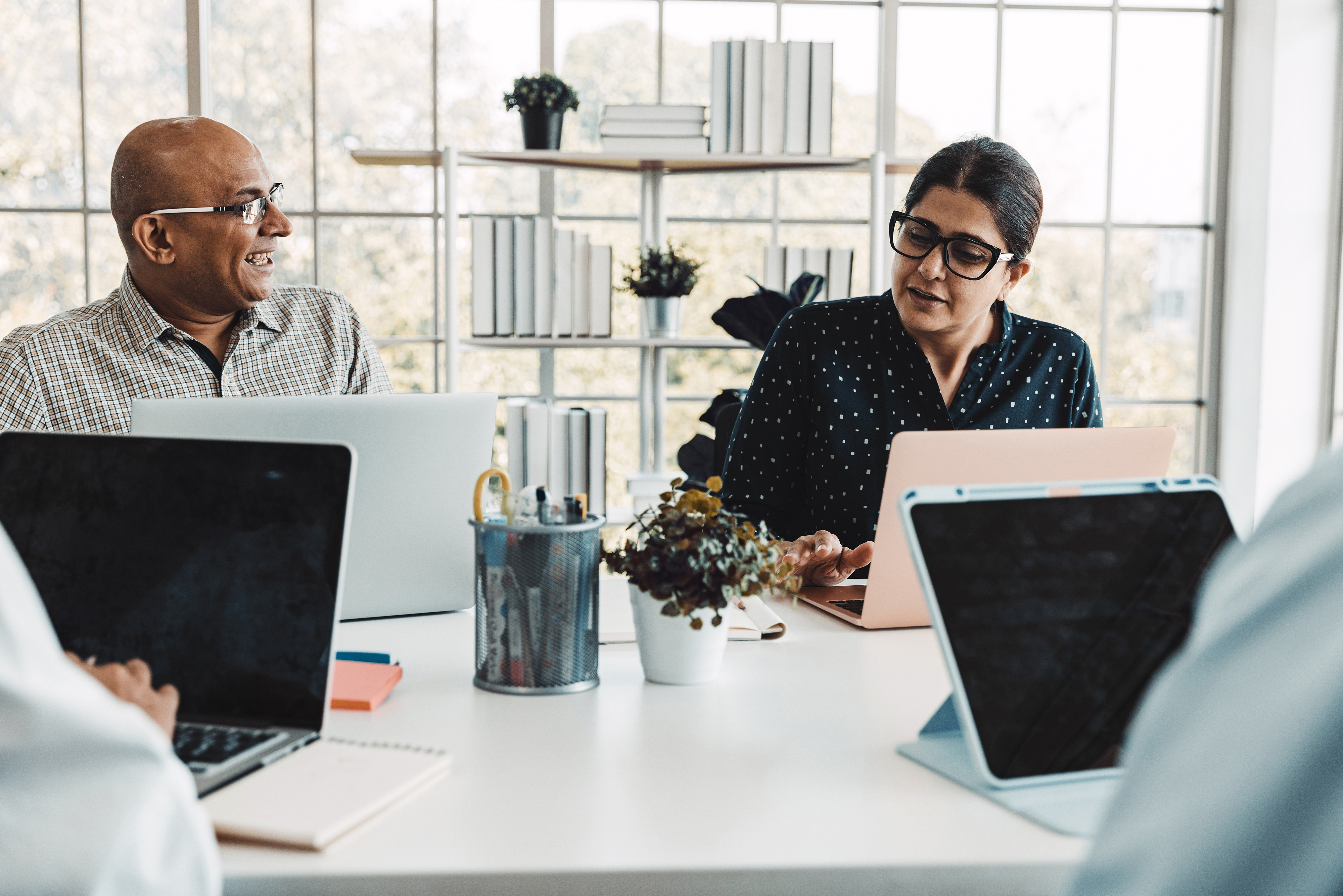 Image of 2 colleagues in a meeting.